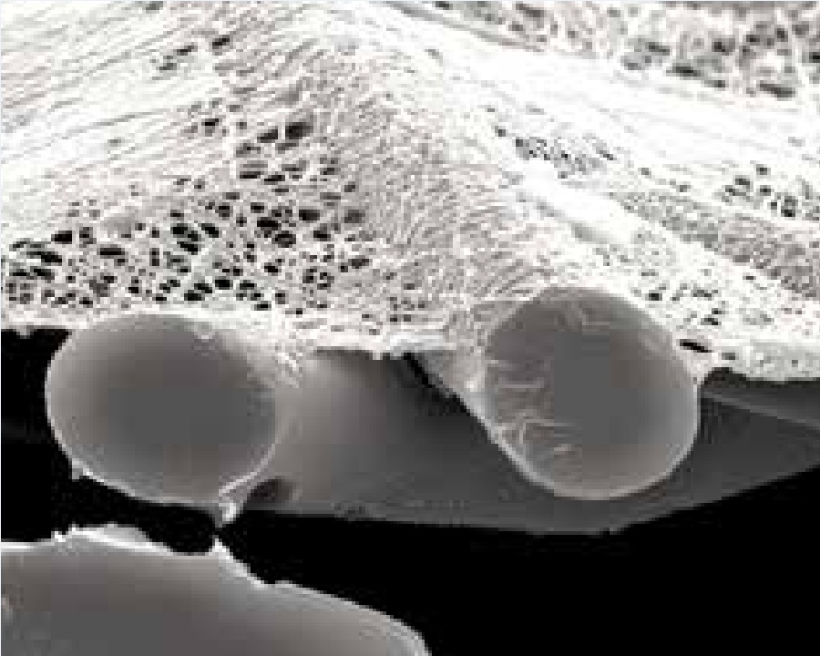 Figure 1 - This shows a filter’s fine fiber media that coats the substrate. This prevents particles from loading into the depths of the filter and makes pulse cleaning effective to help extend filter life.